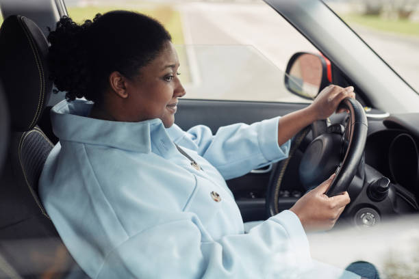 istock Woman Driving Car Side View 1413732209