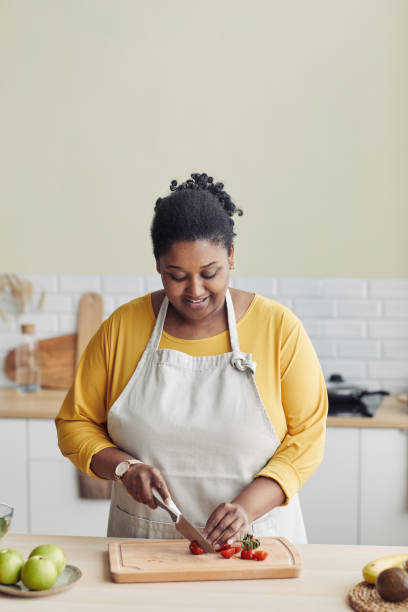 istock Young Woman Cooking in Kitchen 1413732220