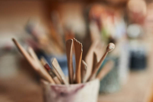 istock Studio, art store and pottery workshop with closeup wood tools, scrapers and shapers for clay, product and ceramic mud. Group of equipment to make, shape and design handmade, artistic or hobby craft 1413732668