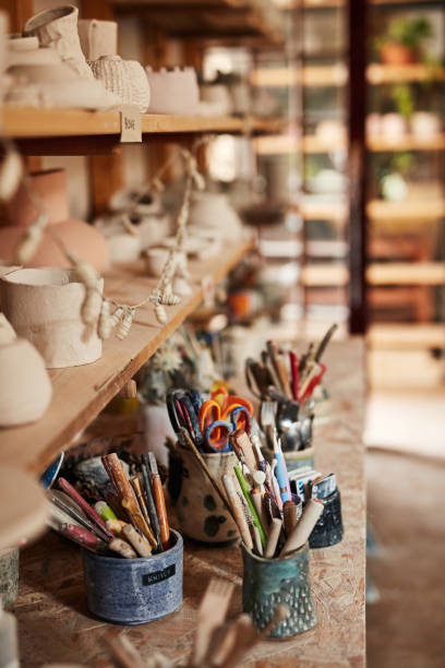 istock Creative, colorful home studio ready for students to paint and make their own pottery indoors. Closeup of a workshop interior with art education tools. An empty artistic working space in the day 1413734533