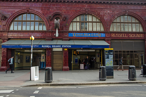London, UK - March 21, 2022: Exterior view of the historic Russell Square Station belonging to London Underground.  The station was designed by Leslie Green with his typical choice of ox blood red ceramic tiles.  It serves the Piccadilly Line.