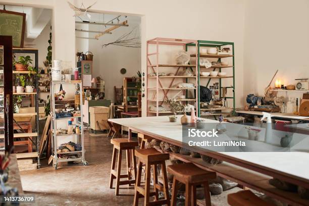 Interior Of Modern Pottery Studio Or Creative Workshop Space Filled With Shelves And Table Of Hand Made Fine Art And Ceramics Clay Molding And Sculpture Class For Culture Crafts With Wood Chairs Stock Photo - Download Image Now