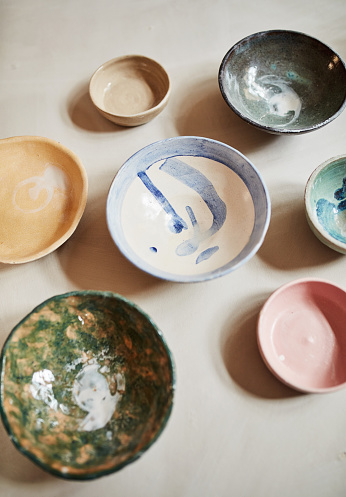 Closeup of beautiful, colorful and pretty clay or ceramic bowls in a studio, art store and pottery workshop. Closeup of homemade, handmade and craft painted product. Group of household hobby crockey