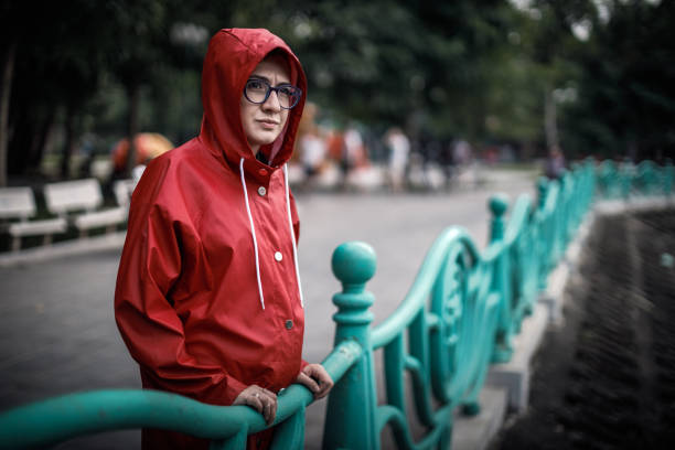 Lonely Moody Girl in a Red Raincoat stock photo