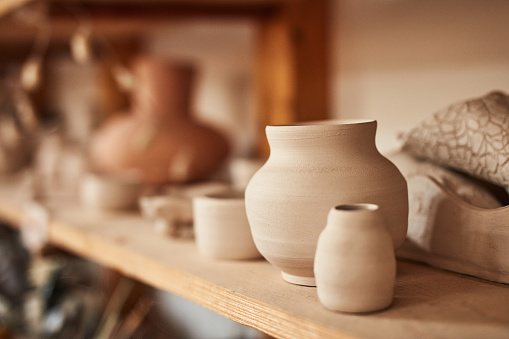 Pottery, ceramic and handmade products on a shelf in a workshop and showroom. Closeup of clay vases and earthenware on display in a craft store. Variety of finished clayware in a small business