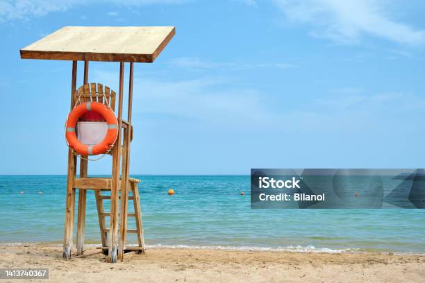 Emplty Wooden Lifeguard Station On Sandy Beach On Ocean Shore In Summer Stock Photo - Download Image Now