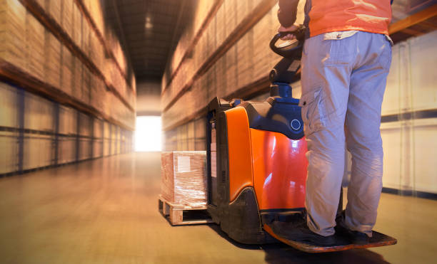 istock Workers Driving Forklift Pallet Jack Unloading Cargo Boxes on Pallet. Supply Chain Shipping Warehouse. Delivery. Shipment Goods. Storage Warehouse Logistics. 1413740503