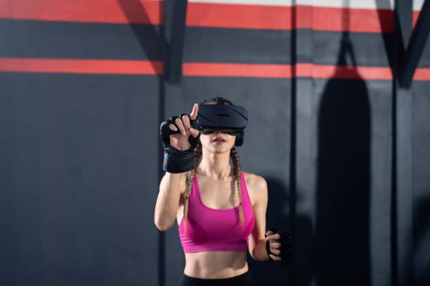 istock Asian woman using virtual reality for exercise at gym. 1413740559