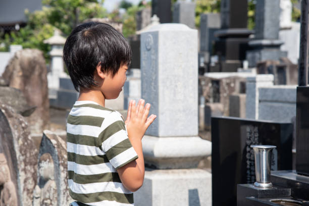 Asian child visiting a grave
