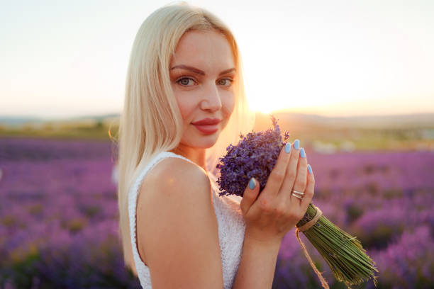 istock Blond haired girl standing in lavender field 1413751405