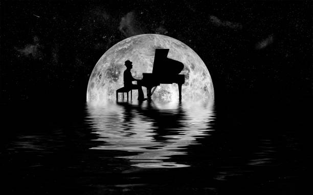Piano player makes music in front of glowing moon with water spouting