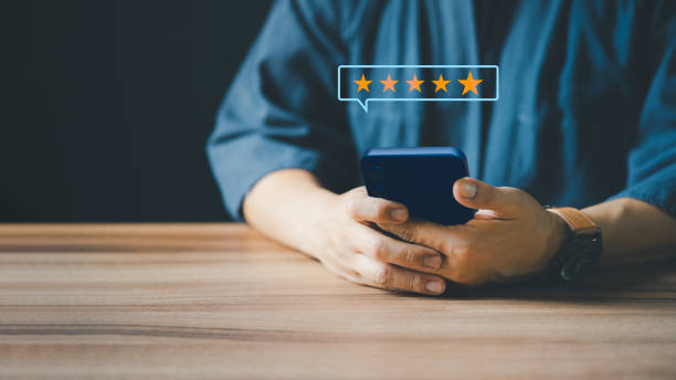 istock Man using a smartphone in give rating to service experience on application. Online customer review satisfaction feedback survey. 1413752778