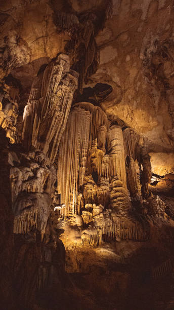 istock photograph of stalactites and stalagmites forming a column 1413752863