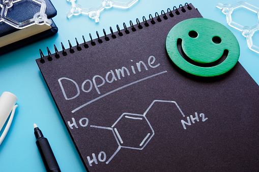 Dopamine chemical formula on a dark page.
