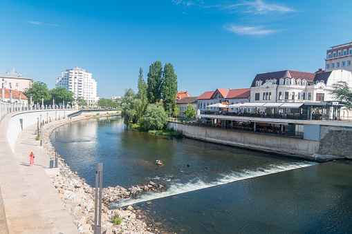 Oradea, Romania - June 10, 2022: Crisul Repede river in city center of Oradea at summer time.