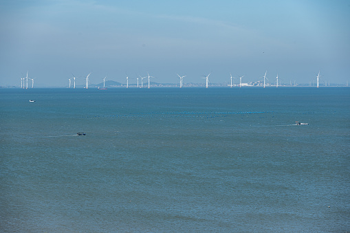 Offshore wind turbine group in sunny days