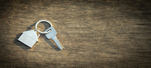 istock House keys on wooden background. 1413755028