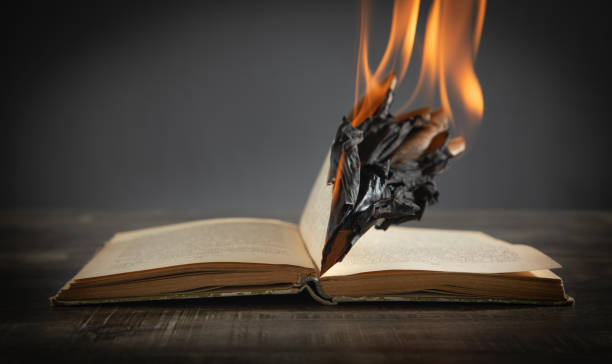 istock Burning book on the wooden table. 1413755107