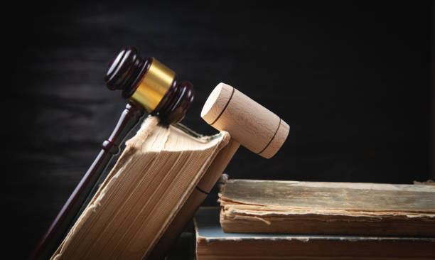 istock Judge gavel and book on the black background. 1413755120