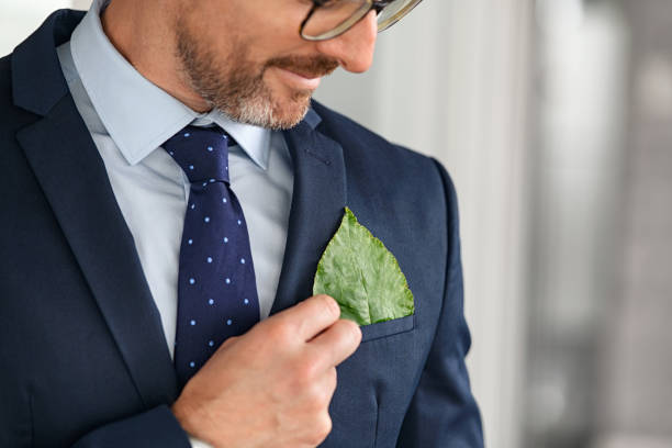 Business man keeping green leaf in pocket stock photo