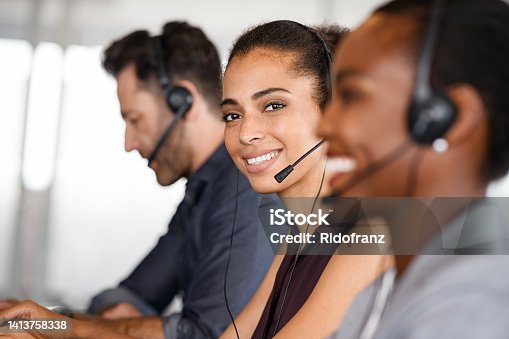 istock Customer service woman smiling at call center 1413758338