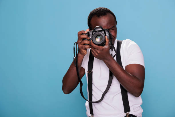 istock Confident professional photographer having DSLR camera taking picture 1413759367