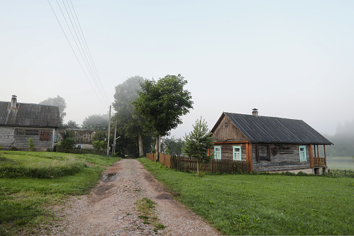 summer picturesque rustic landscape with wooden house. country scene