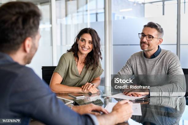 Mature Couple Meeting Financial Advisor For Investment Stock Photo - Download Image Now