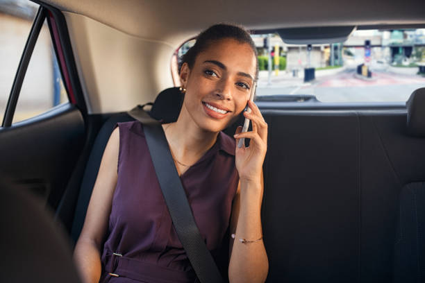 istock Black woman in car talking on phone while going to work 1413761480