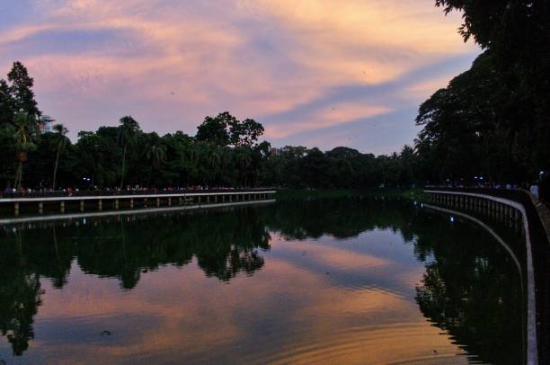 istock Sky, clouds, lake and walkway in a park 1413762596