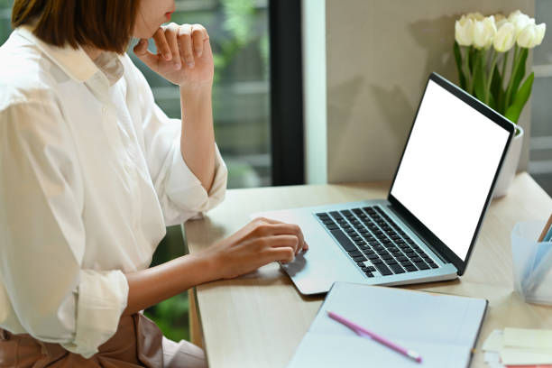 istock Female freelancer working online, reading online information on her laptop computer. 1413762754