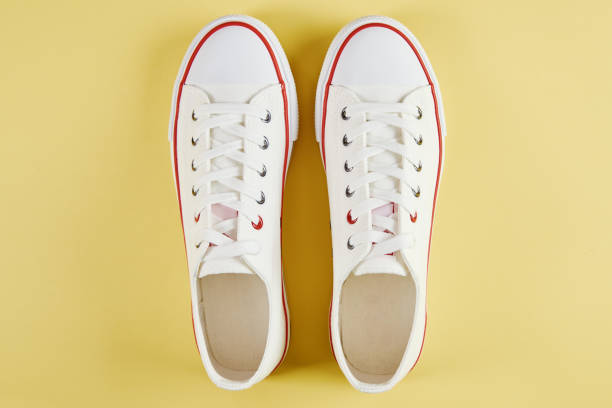 istock Casual sneakers on yellow background, creative minimalism 1413762790