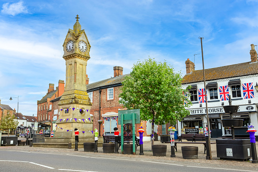 91 High Street in Tonbridge, England. This is where PizzaExpress is located in the high street. There is a clock tower and a weather vane.