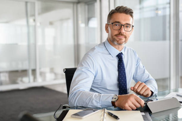 Confident businessman working on digital tablet stock photo