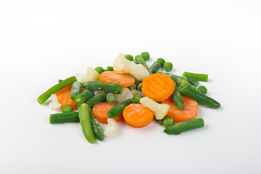 Frozen mixed vegetables on white. Handmade clipping path.