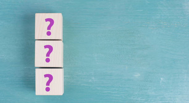 istock Three wooden cubes with question marks in purple color, looking for an answer, customer service 1413768450