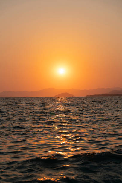 Sunset at the sea stock photo Sunset over the sea, background, sun is up, Fethiye doing the wave stock pictures, royalty-free photos & images