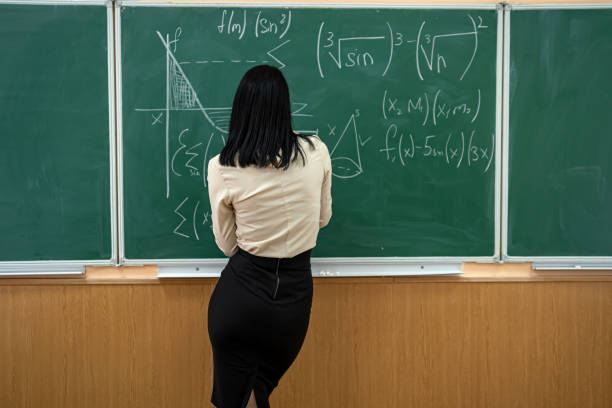 istock young teacher or student standing near blackboard and learn math lesson 1413769625