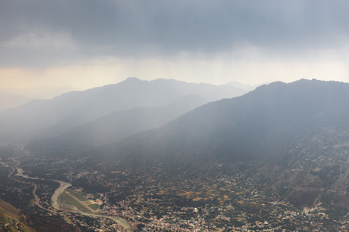 Aerial view of kullu city and Bhuntar airport during heavy rains. Shot from on top of Bijli Mahadev mountain at 2500m.
