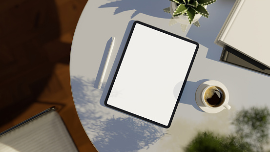 Digital tablet touchpad white screen mockup and accessories on modern white table. top view, workspace. 3d rendering, 3d illustration