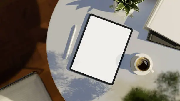 Photo of Digital tablet white screen mockup on modern white table. top view, workspace.