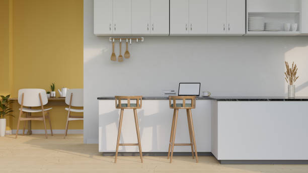istock Modern stylish kitchen cooking space interior with kitchen counter, laptop on kitchen island and stools. 1413771119