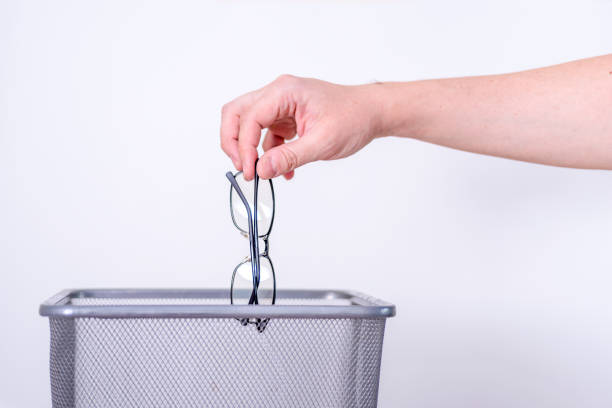 Glasses are thrown in the trash for recycling and disposal.