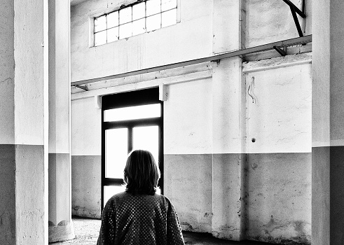 Woman silhouette in abandoned industrial building.
