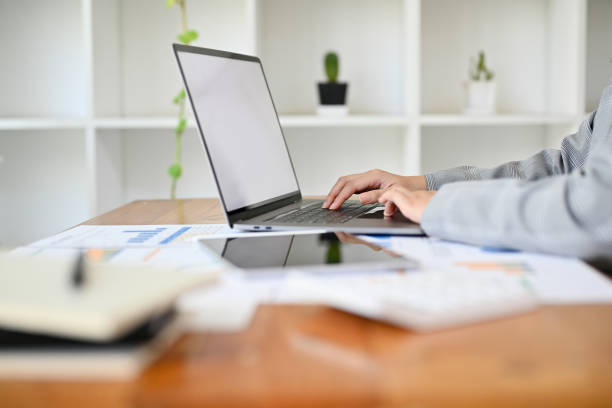 istock Businesswoman sits at her office desk working on her project, using laptop. cropped image 1413772245