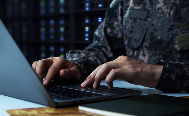 istock Soldier in camouflage uniform working on laptop for Information 1413772643