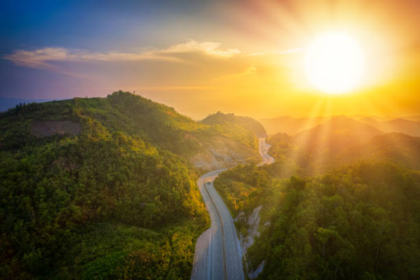 istock Beautiful morning sky with the road between mountains and sunshine. 1413772973