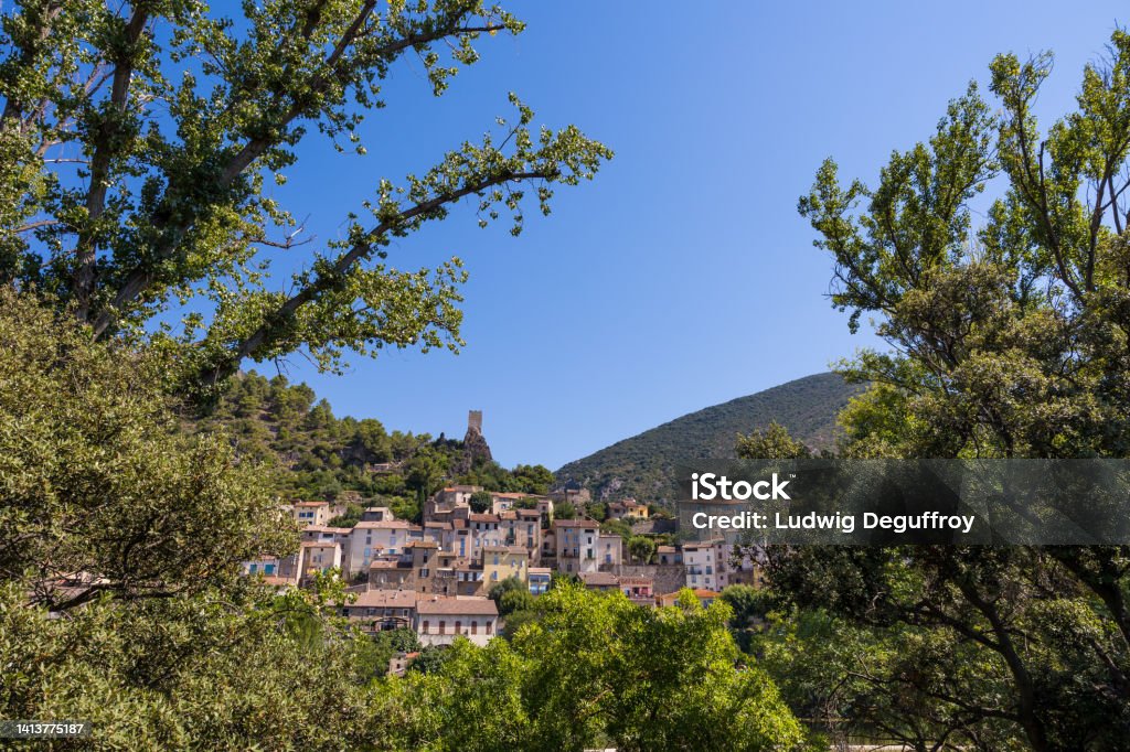 Summer view on the village of Roquebrun from the banks of the Orb River Architecture Stock Photo