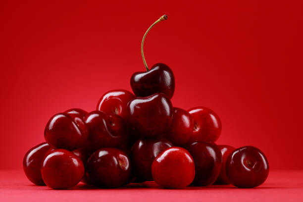 istock Tasty ripe red cherries on a red background. 1413778580