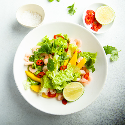 Fresh green salad with shrimps and mango